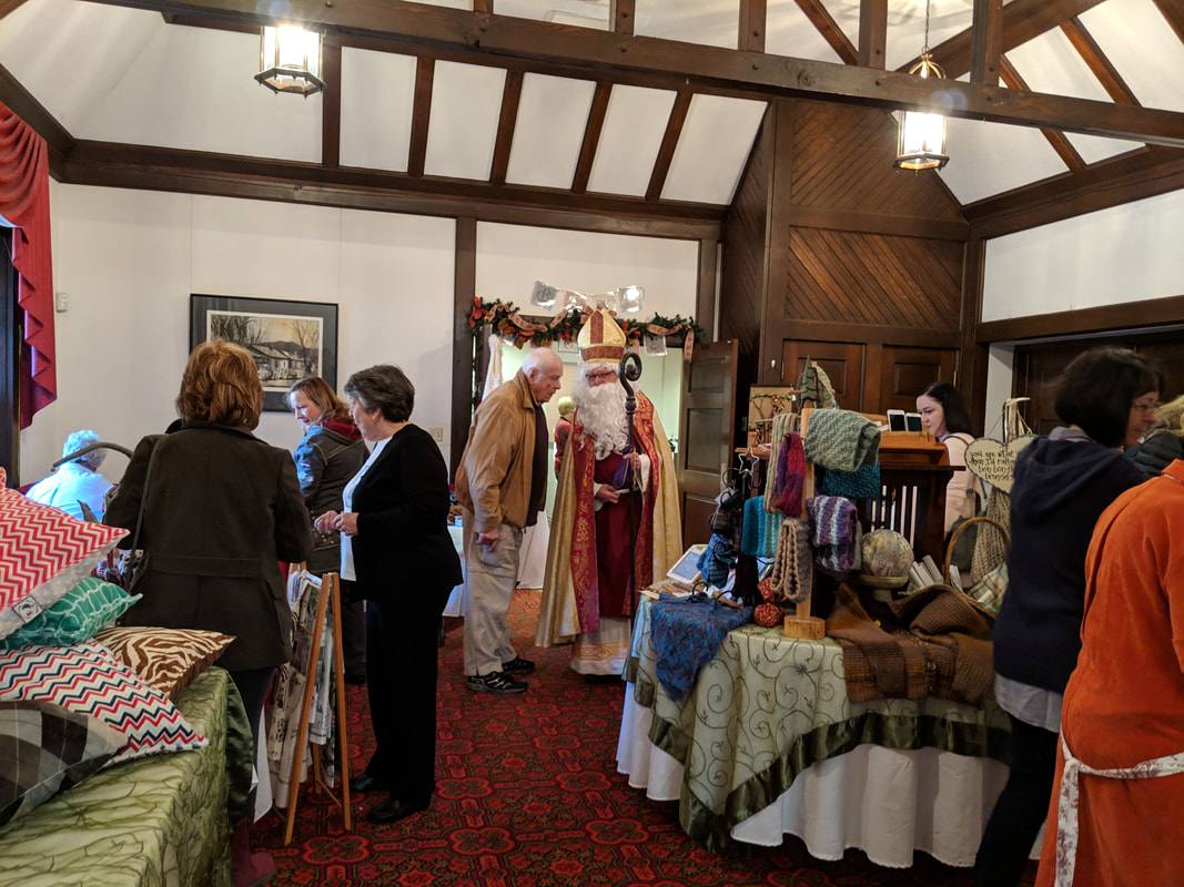 Photo of tables and shoppers at Harvest Bazaar.