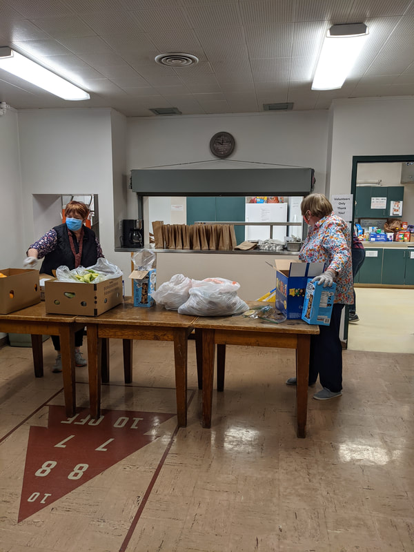 Volunteers preparing sack lunches to distribute to those who are hungry.